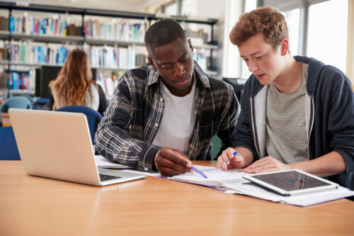 Students collaborating on a project in library