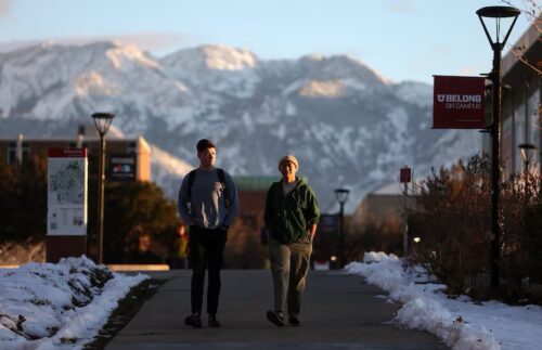 Two men walking on wintry college campus
