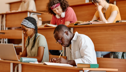 Students take notes during a college lecture